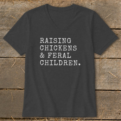 Dark gray v-neck t-shirt with white text: Raising Chickens & Feral Children.