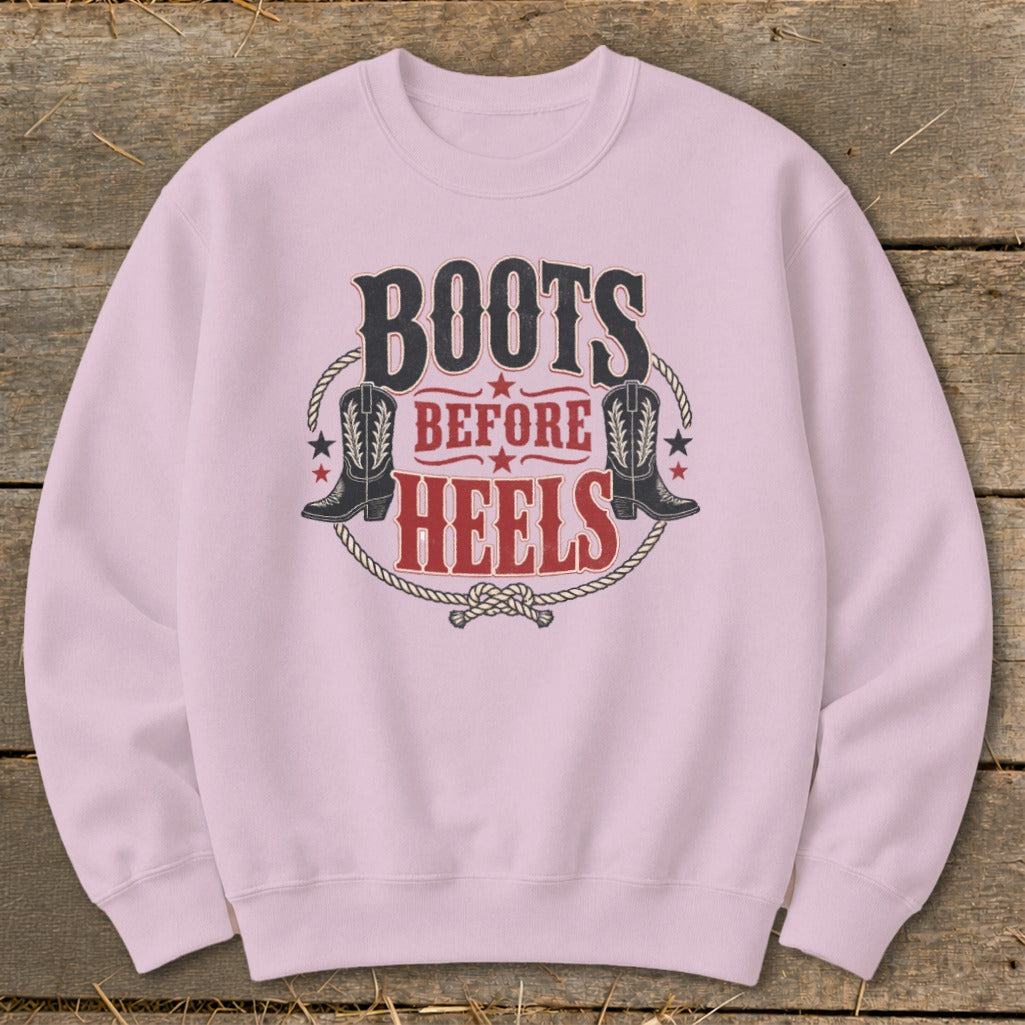 Pink sweatshirt with "Boots Before Heels" text and cowboy boot graphics.