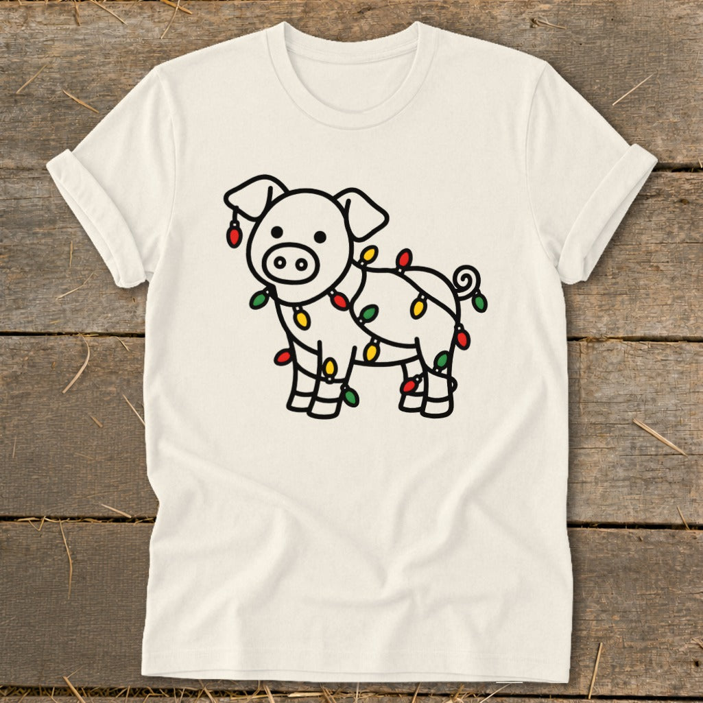Off-white crewneck t-shirt featuring a line drawing of a pig tangled in colorful Christmas lights.