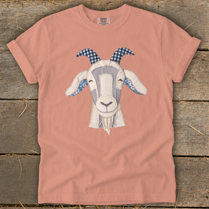 Peach t-shirt with a stitched goat face applique and Comfort Colors logo.