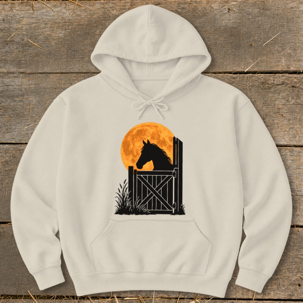 Cream-colored hooded sweatshirt featuring a graphic of a horse's silhouette in a stable against a large orange moon.