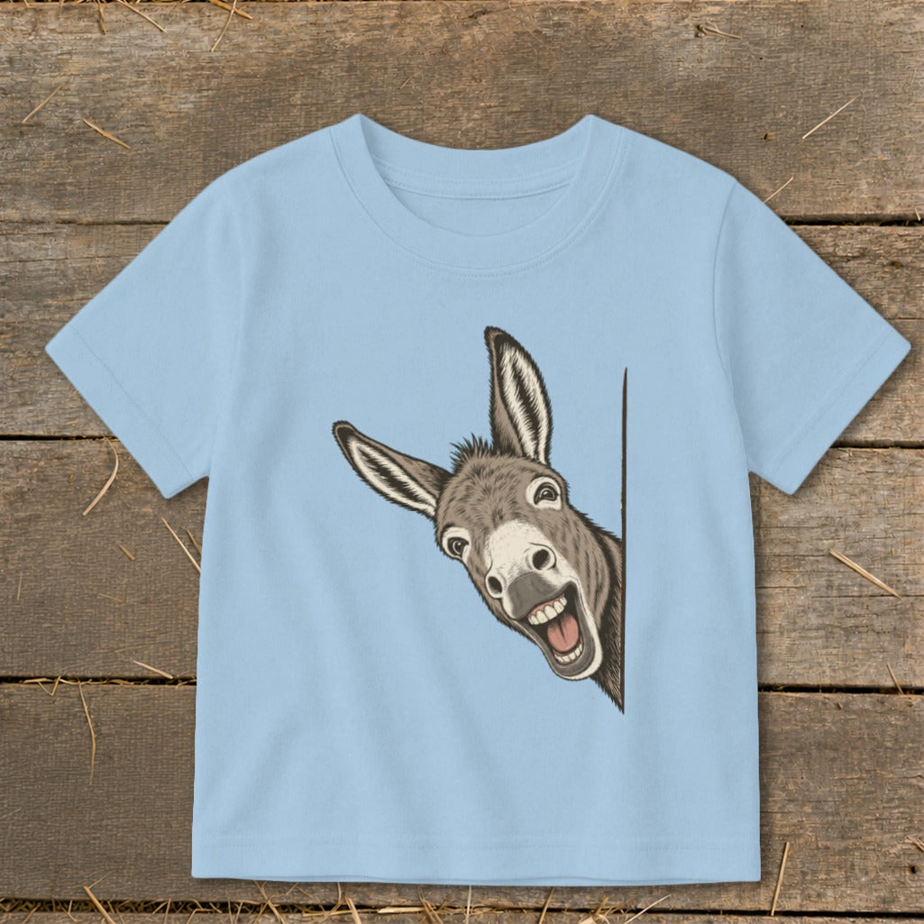 Light blue t-shirt with a cartoon donkey peeking around the side and smiling.