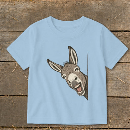Light blue t-shirt with a cartoon donkey peeking around the side and smiling.