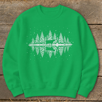 Green sweatshirt with white reflection of trees and a cabin in the snow.