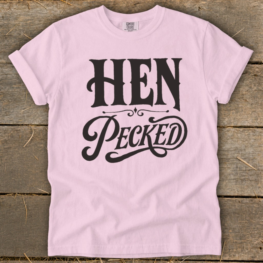 Pink t-shirt with black text "HEN PECKED" and "COMFORT COLORS" label.