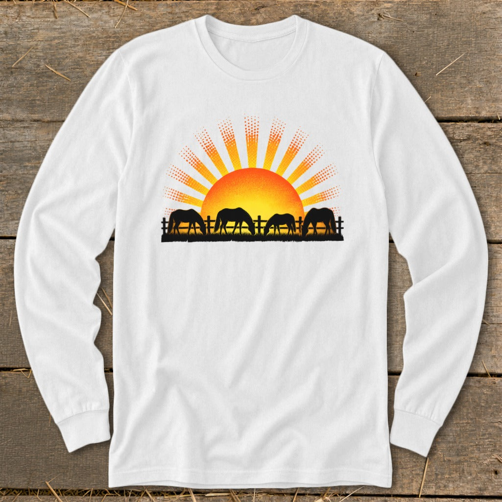 Silhouette of four horses grazing at sunset with a sunburst design.