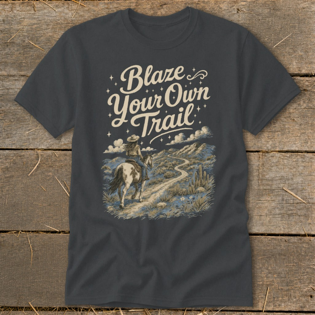 T-shirt graphic: "Blaze Your Own Trail" text, person riding horse on desert path.