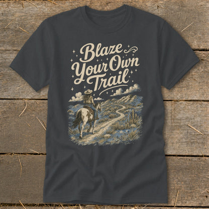 T-shirt graphic: "Blaze Your Own Trail" text, person riding horse on desert path.
