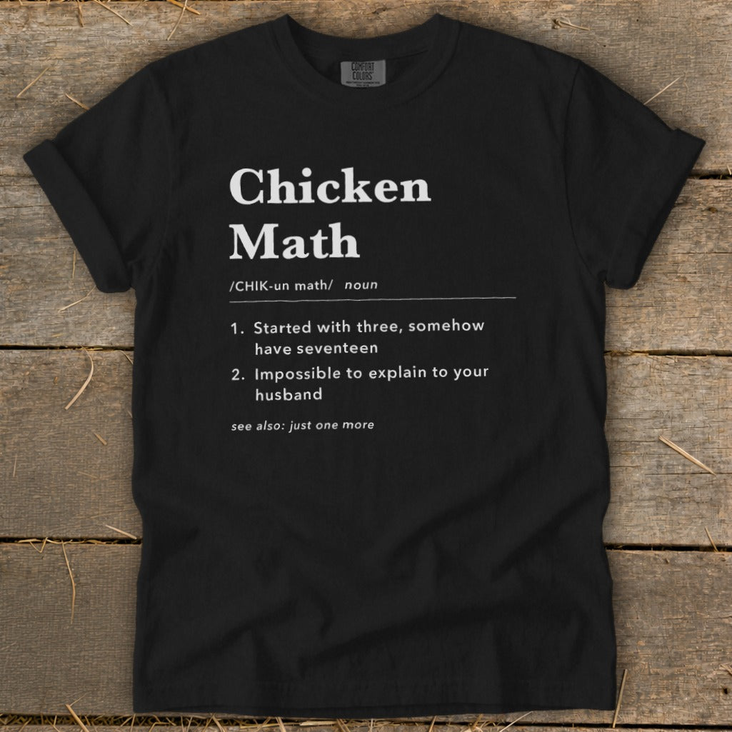 Black t-shirt with white text defining "Chicken Math" and its humorous explanations.