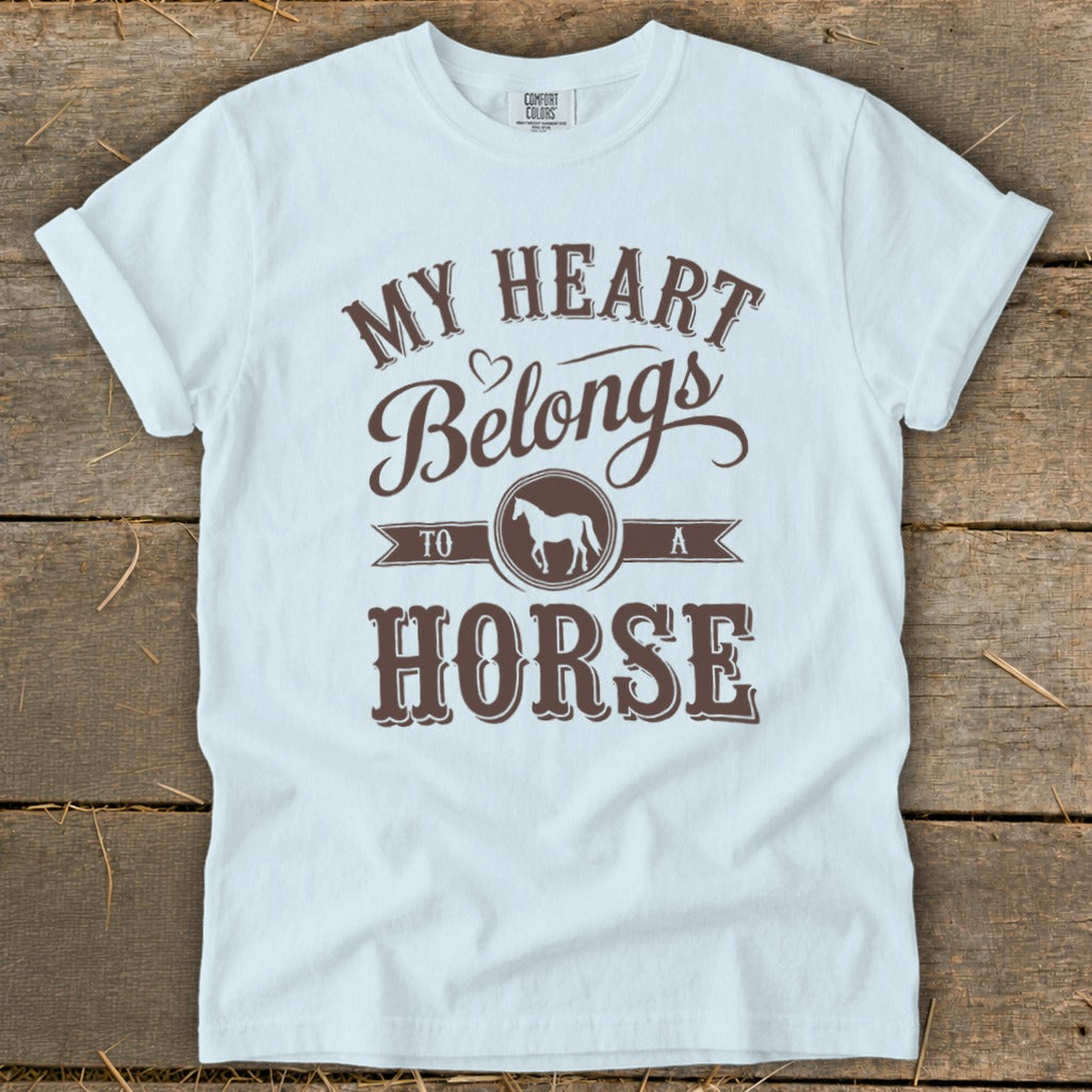 White t-shirt with brown text "My Heart Belongs To A Horse" and horse graphic.
