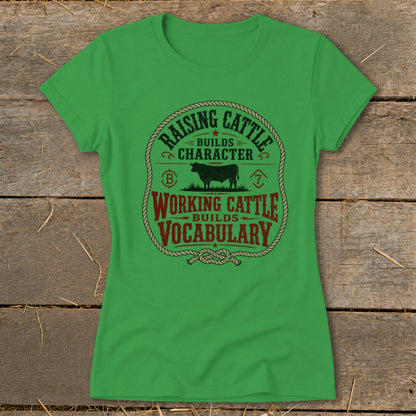 Green t-shirt with "Raising Cattle Builds Character, Working Cattle Builds Vocabulary" text and cow graphic.
