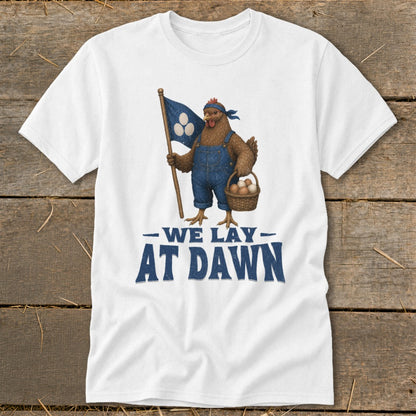 White t-shirt with chicken in overalls holding flag and egg basket, text "WE LAY AT DAWN".