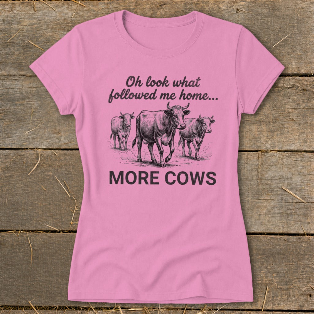 Pink t-shirt with three cows and text "Oh look what followed me home... MORE COWS".