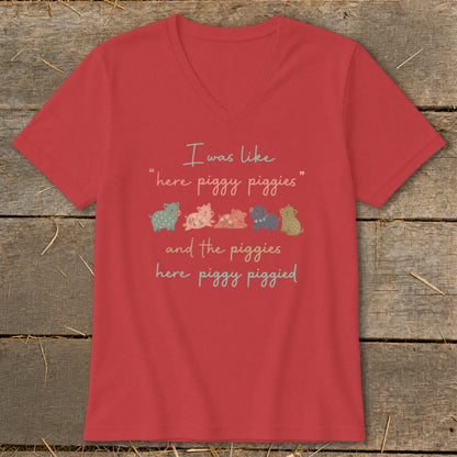 Red t-shirt with text and five cartoon pigs.