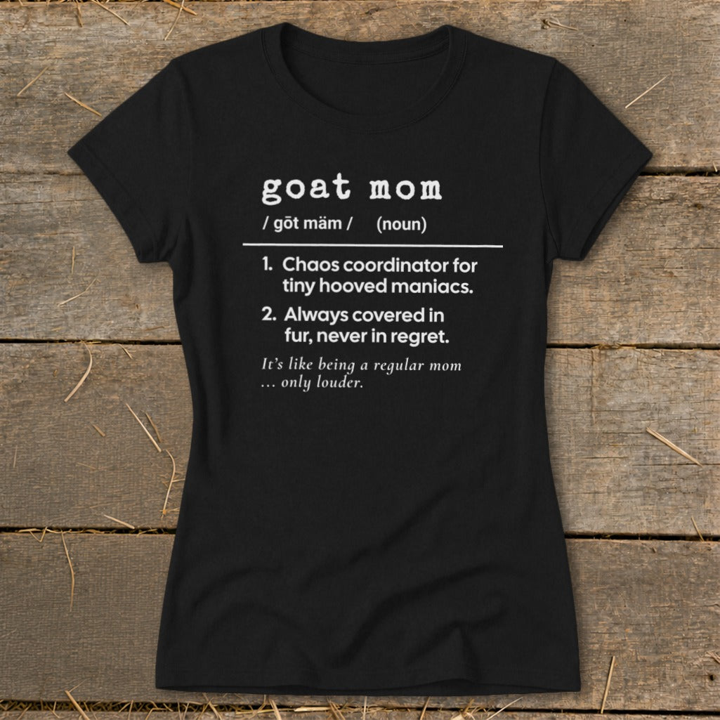 Black t-shirt with white text defining "goat mom" as chaos coordinator for tiny hooved maniacs.