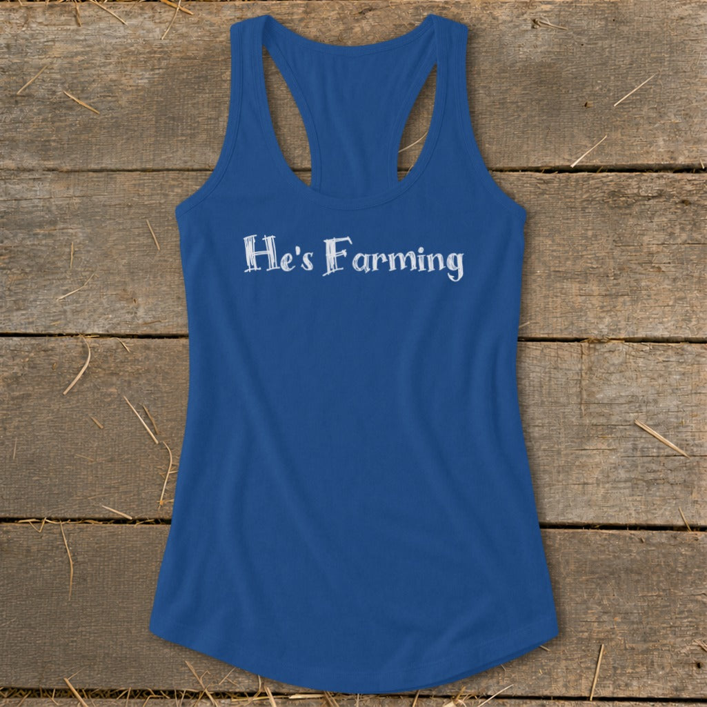 Blue racerback tank top with white text "He's Farming".