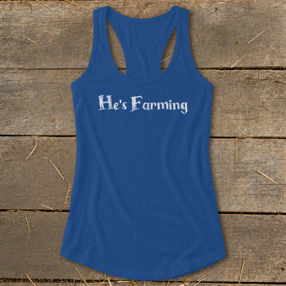 Blue racerback tank top with white text "He's Farming".