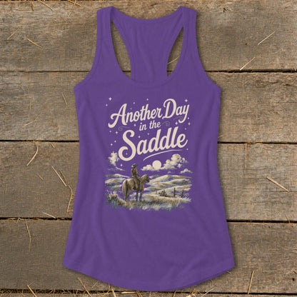 Purple tank top with "Another Day in the Saddle" text and cowboy on horseback graphic.