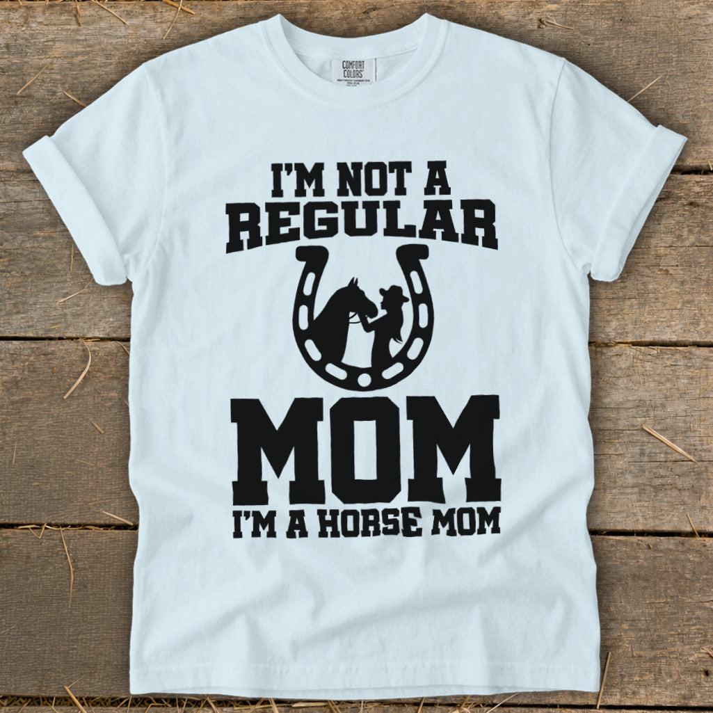 White t-shirt with "I'm Not a Regular Mom, I'm a Horse Mom" text and horseshoe graphic.