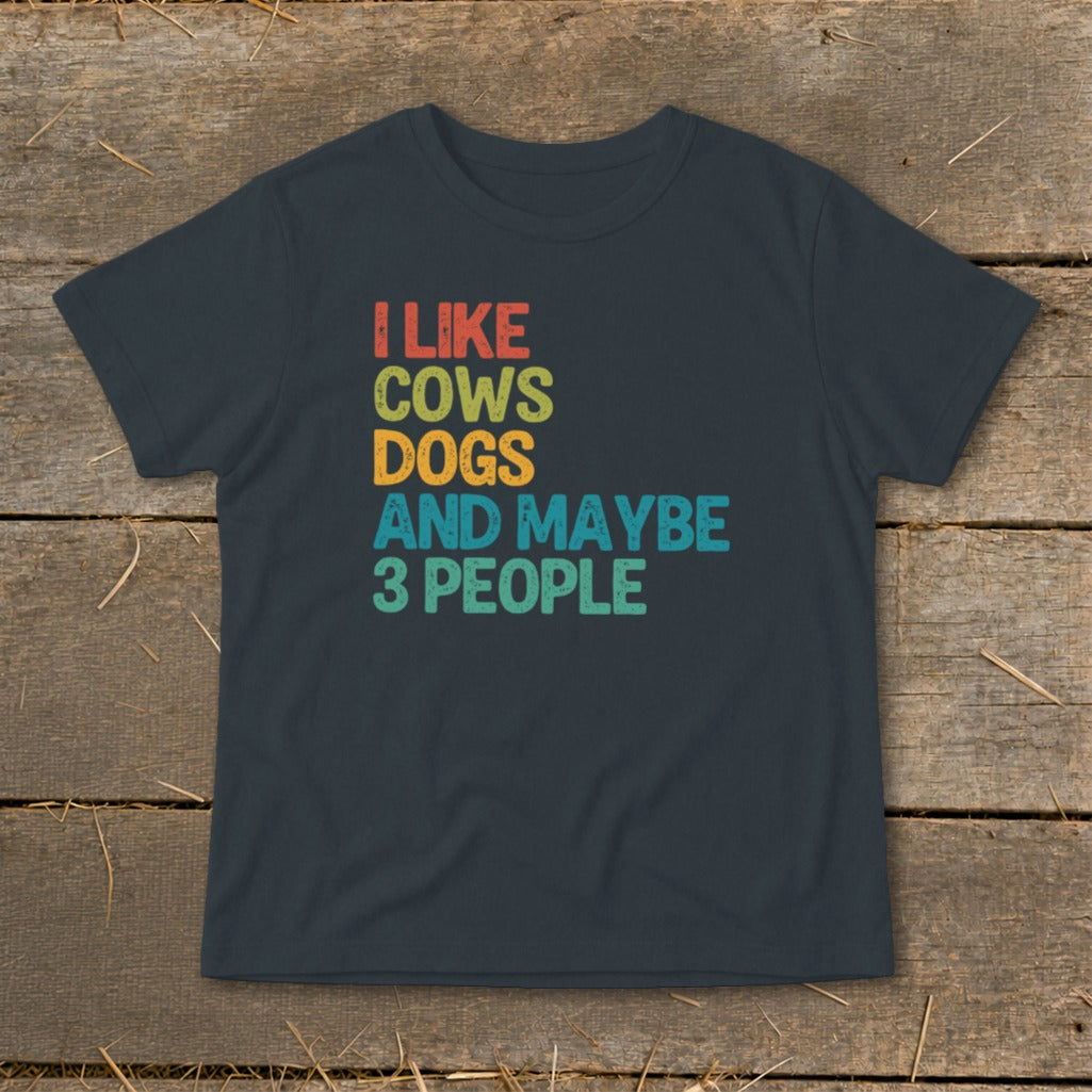 Dark grey t-shirt featuring distressed retro text that reads I LIKE COWS DOGS AND MAYBE 3 PEOPLE.