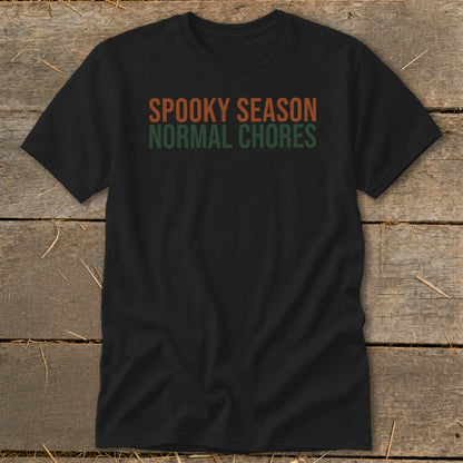 Black t-shirt with orange and green text reading "SPOOKY SEASON NORMAL CHORES".