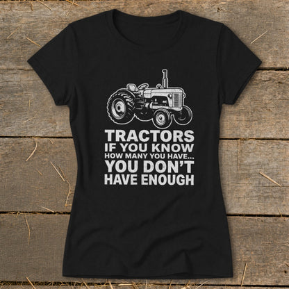 Black t-shirt with a tractor graphic and text "Tractors if you know how many you have... you don't have enough."