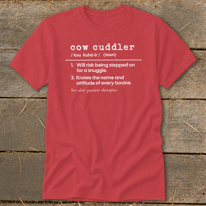 Red t-shirt with "cow cuddler" definition: Will risk being stepped on for a snuggle.