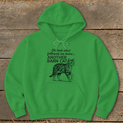 Green hoodie with text and line drawing of a walking cat.