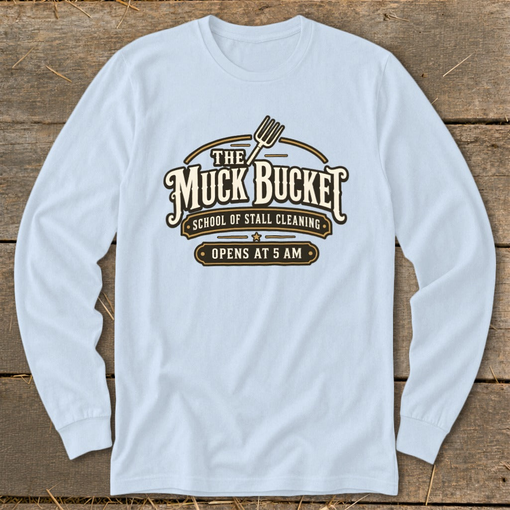Light blue long-sleeve shirt with "The Muck Bucket School of Stall Cleaning Opens at 5 AM" graphic.