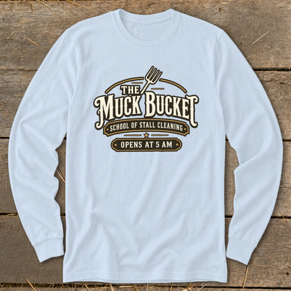 Light blue long-sleeve shirt with "The Muck Bucket School of Stall Cleaning Opens at 5 AM" graphic.