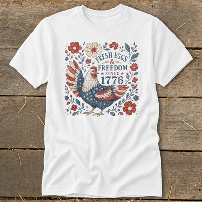 White t-shirt with patriotic chicken and "Fresh Eggs & Freedom Since 1776" text.