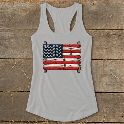 Light gray racerback tank top featuring a graphic of the American flag made from weathered wood planks and horseshoes.