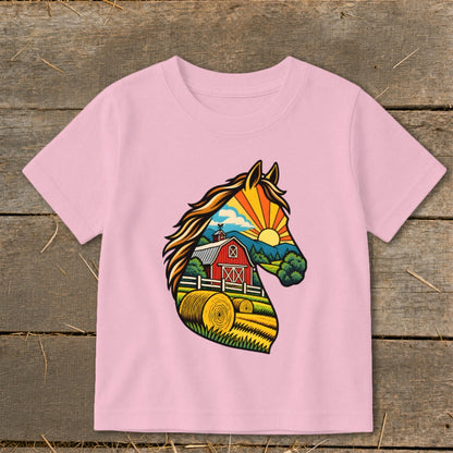 A light pink children's t-shirt features a colorful graphic of a horse head filled with a farm scene.