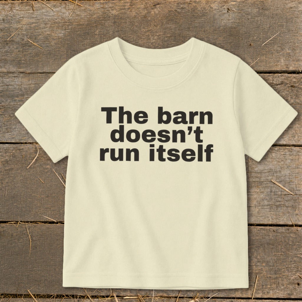 Cream t-shirt with black text: "The barn doesn't run itself".