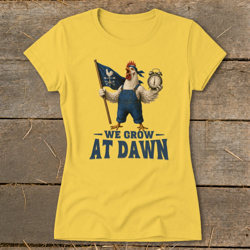 Yellow t-shirt with a rooster in overalls holding a flag and alarm clock, saying "We Grow At Dawn".
