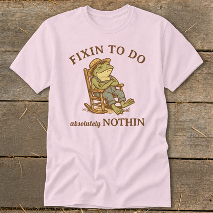 Pink t-shirt with frog in rocking chair, text: "FIXIN TO DO absolutely NOTHIN"