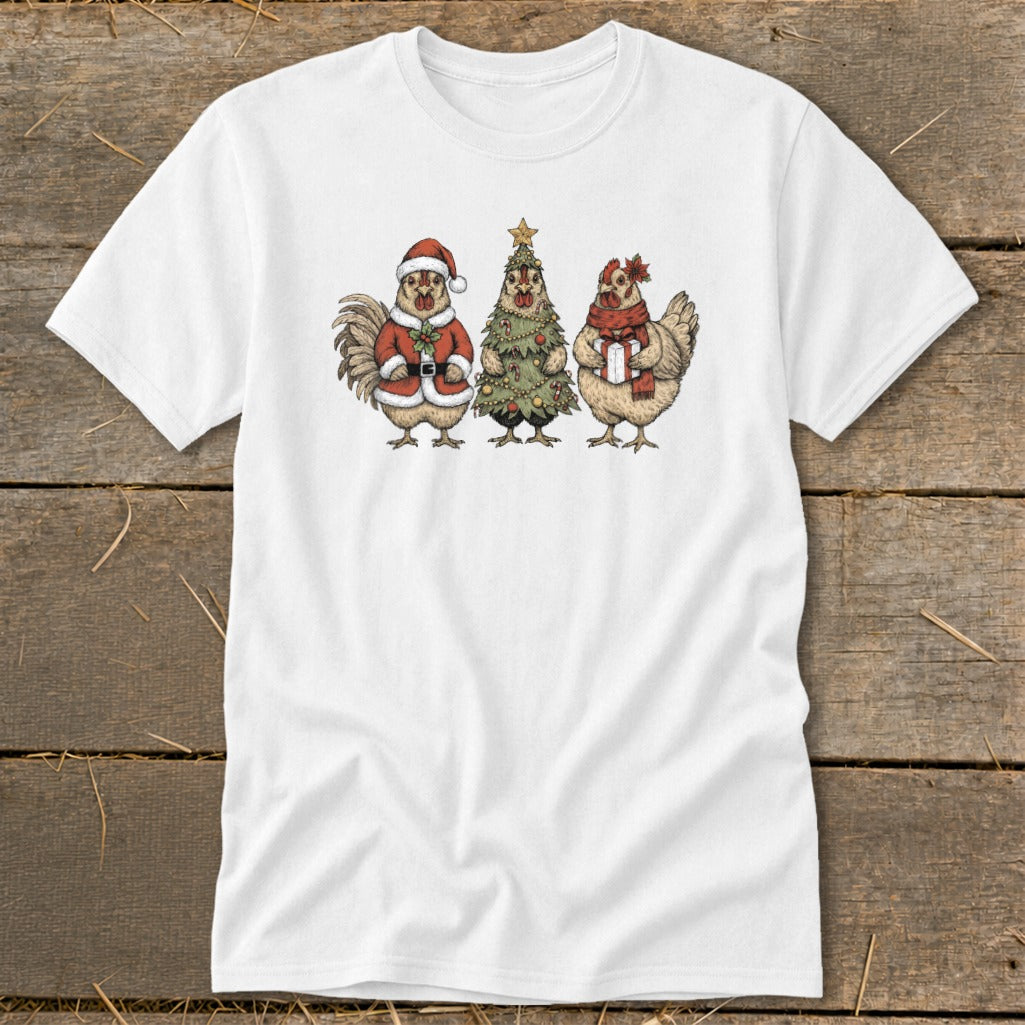 Three chickens, one dressed as Santa, next to a Christmas tree and a gift.