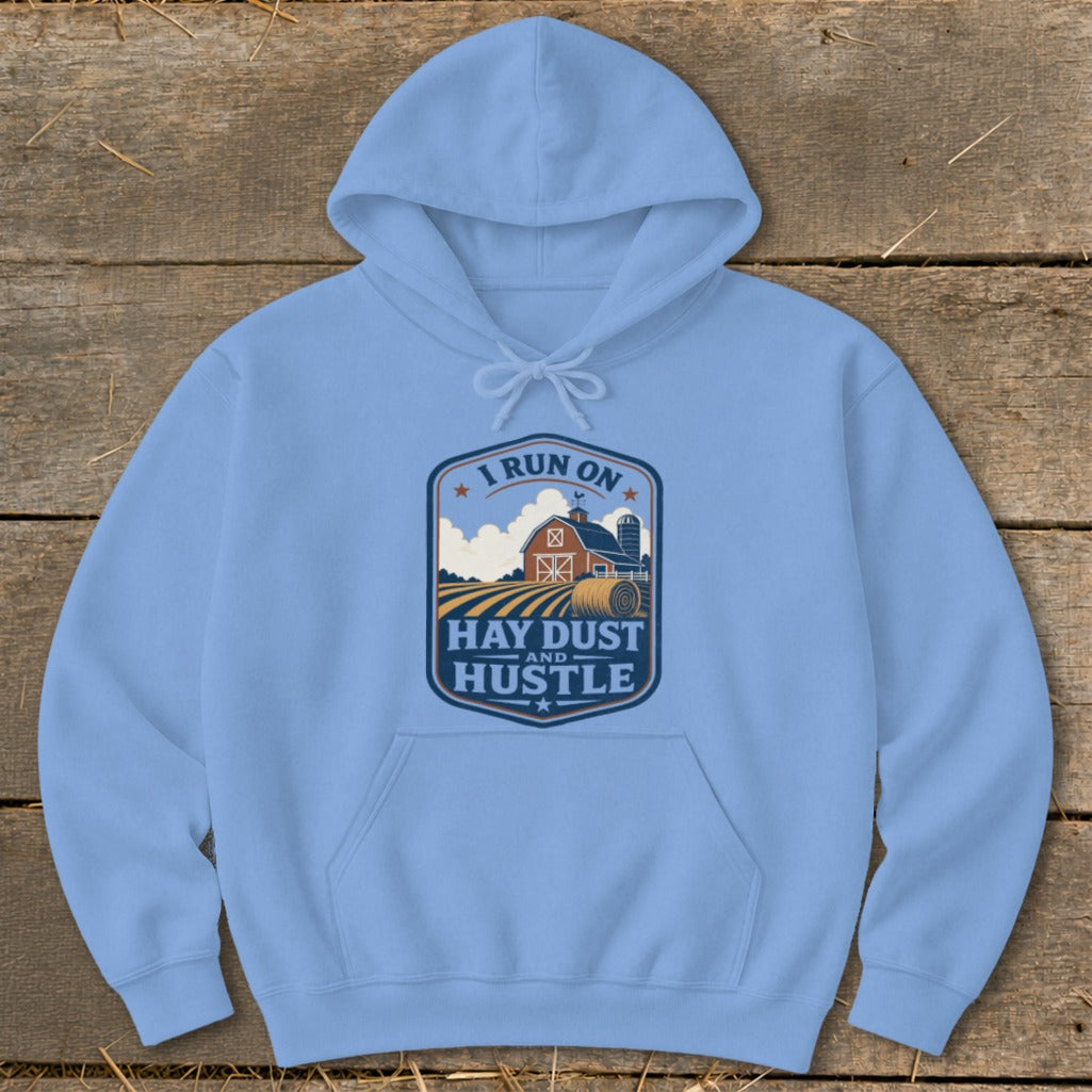 Light blue hoodie with a crest graphic saying "I Run On Hay Dust And Hustle"