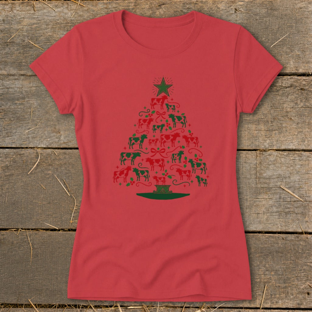 Red t-shirt with a Christmas tree made of red and green cows, holly, and bows.
