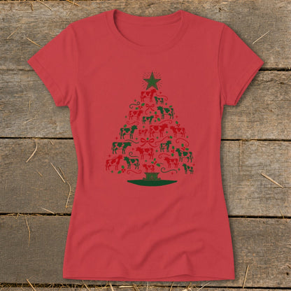 Red t-shirt with a Christmas tree made of red and green cows, holly, and bows.