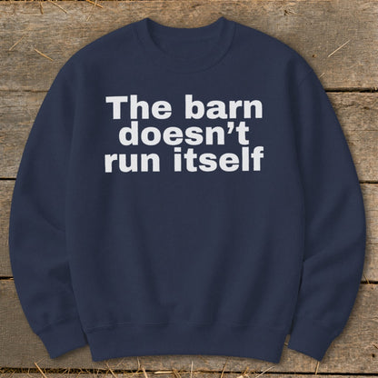 Navy sweatshirt with white text reading "The barn doesn't run itself".