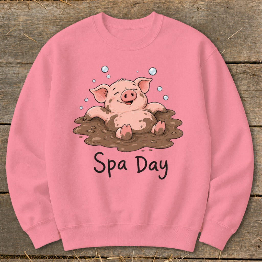 Pink sweatshirt with a cartoon pig enjoying a mud bath and text that reads "Spa Day".