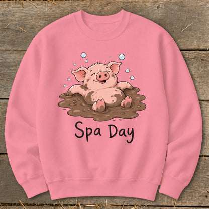 Pink sweatshirt with a cartoon pig enjoying a mud bath and text that reads "Spa Day".