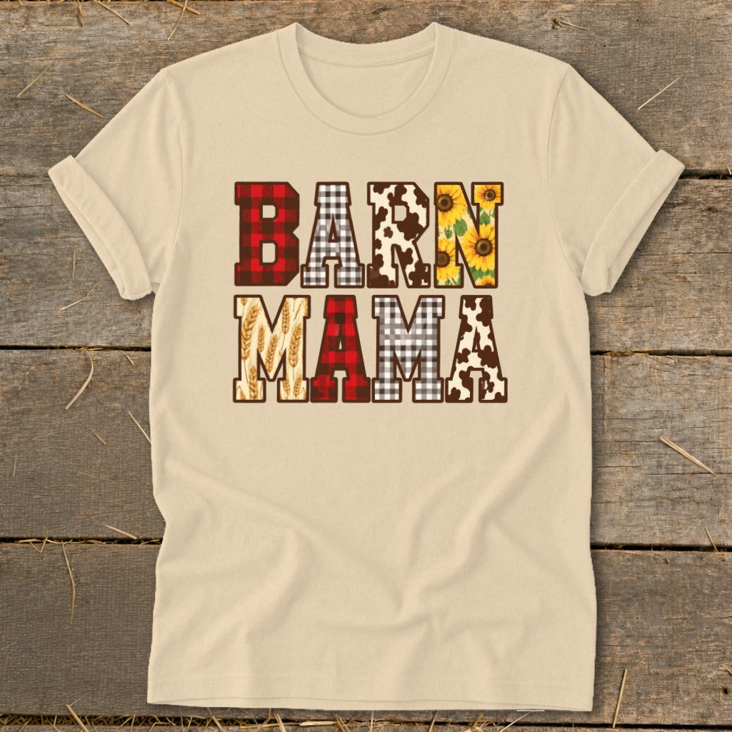 Light tan t-shirt with "BARN MAMA" text featuring buffalo plaid, cow print, sunflowers, and wheat.