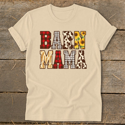 Light tan t-shirt with "BARN MAMA" text featuring buffalo plaid, cow print, sunflowers, and wheat.