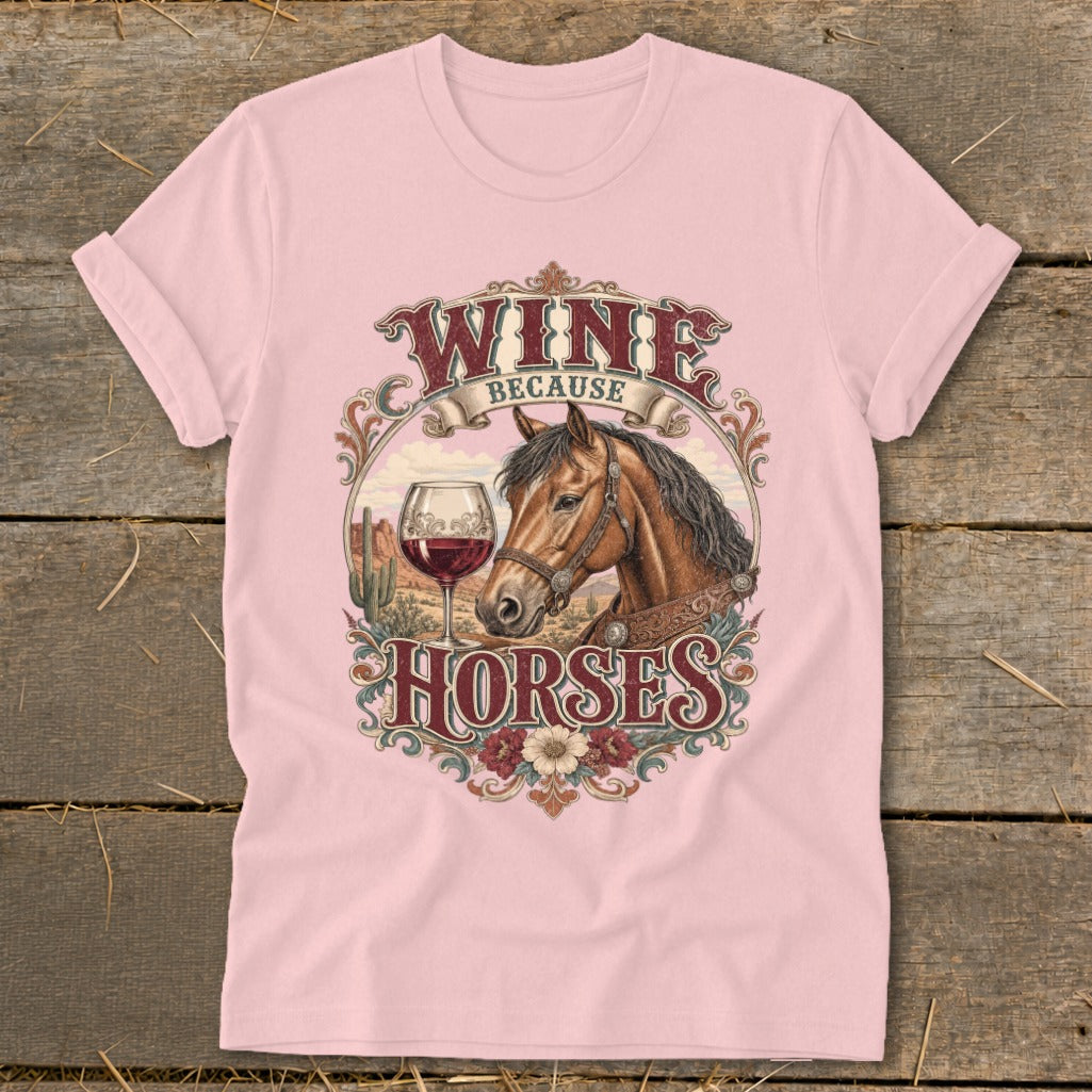 Pink t-shirt with a graphic of a horse, wine glass, and desert landscape. Text reads "WINE BECAUSE HORSES".
