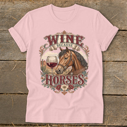 Pink t-shirt with a graphic of a horse, wine glass, and desert landscape. Text reads "WINE BECAUSE HORSES".