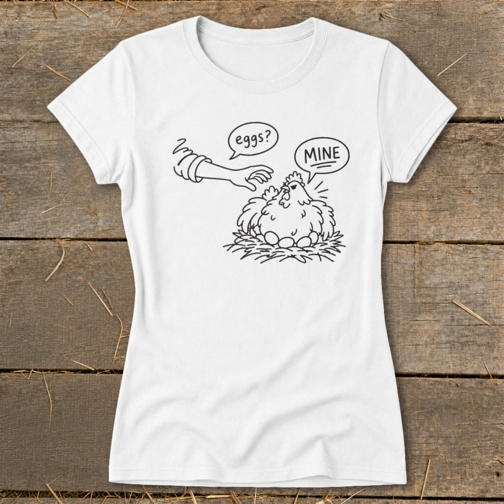 T-shirt with illustration of a chicken on a nest with eggs, and a hand saying "eggs?".