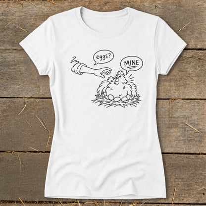 T-shirt with illustration of a chicken on a nest with eggs, and a hand saying "eggs?".