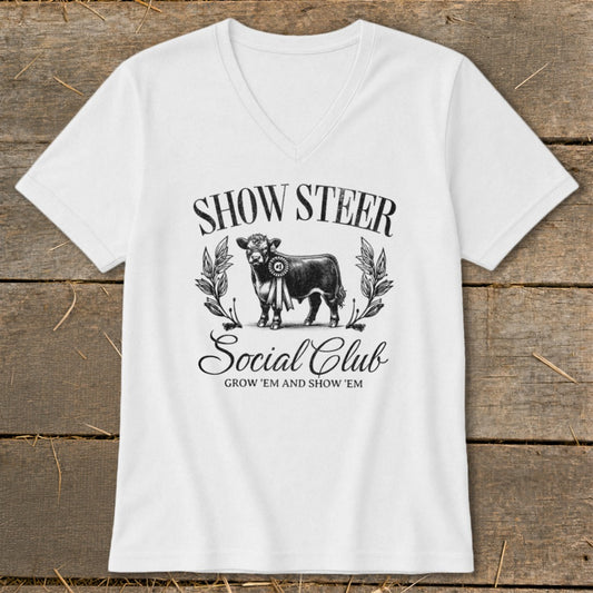 White t-shirt with "SHOW STEER Social Club GROW 'EM AND SHOW 'EM" text and a steer graphic.